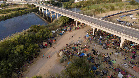 Migrants, many from Haiti, are seen at an encampment along the Del Rio International Bridge near the Rio Grande in Texas