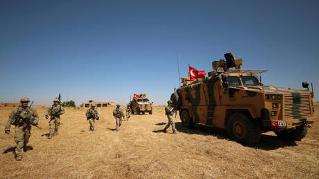 American and Turkish soldiers walk together during a joint U.S.-Turkey patrol, near Tel Abyad, Syria September 8, 2019. © REUTERS/Rodi Said