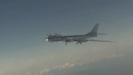 Russian strategic missile jets soar through skies as onboard gunners let off anti-aircraft salvos in major readiness exercises