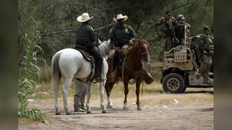 US Border Patrol officers are shown last week, standing guard near the International Bridge in Del Rio, Texas.