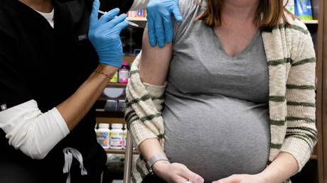 FILE PHOTO: A pregnant woman receives a Covid vaccine at a pharmacy in Schwenksville, Pennsylvania.
