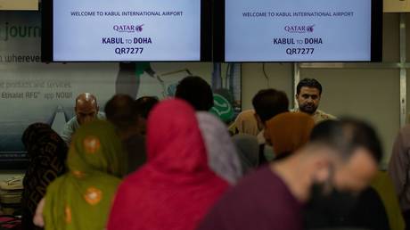 FILE PHOTO: Passengers stand in line to check-in at Kabul International Airport, in Kabul, Afghanistan September 19, 2021.