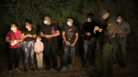 Migrants are lined up and processed by US Border Patrol in Roma, Texas