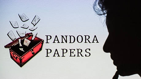 This photograph illustration shows a woman's shadow cast on the logo of Pandora Papers, in Lavau-sur-Loire, western France, on October 4, 2021. © LOIC VENANCE / AFP