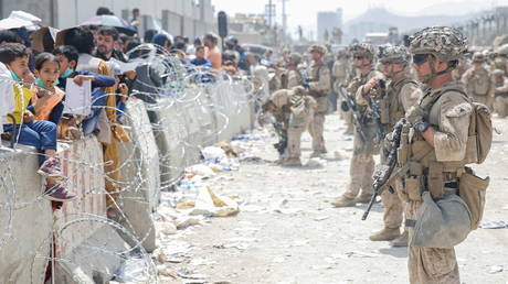 US Marines provide assistance during evacuation at Hamid Karzai International Airport, in Kabul, Afghanistan