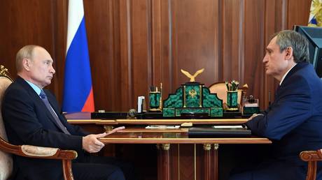 FILE PHOTO: Russian President Vladimir Putin (L) meets Energy Minister Nikolay Shulginov (R).