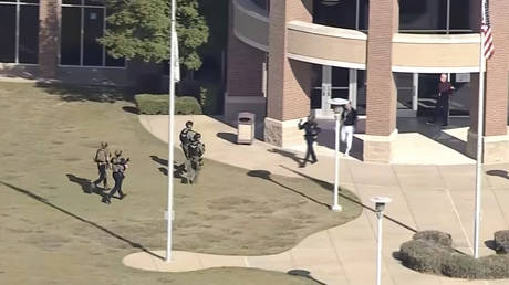 Law enforcement arrives at Timberview High School on Wednesday, Oct. 6, 2021 in Arlington, Texas. © WFAA-TV via AP