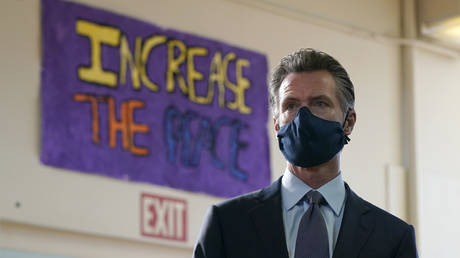 FILE PHOTO. Gov. Gavin Newsom listens to speakers during a news conference at James Denman Middle School in San Francisco, Friday, Oct. 1, 2021.