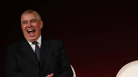 FILE PHOTO: Britain's Prince Andrew laughs at a joke by former U.S. Secretary of State Hillary Rodham Clinton, after she was awarded with the Chatham House Prize award in central London, Friday, Oct. 11, 2013. © AP Photo/Lefteris Pitarakis
