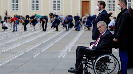 FILE PHOTO: Czech President Milos Zeman watches as employees of Prague Castle light candles to commemorate Covid-19 victims in Prague, Czech Republic, May 10, 2021.