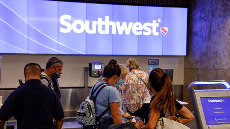 Passengers check in for a Southwest Airlines flight at Orlando International Airport in Orlando