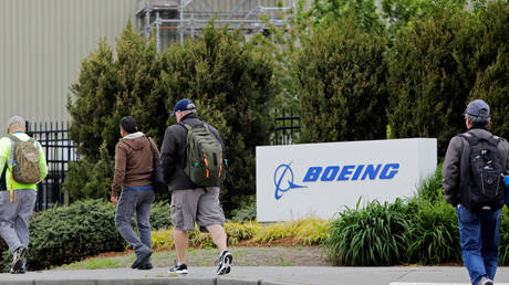 FILE PHOTO: Workers head into a Boeing factory in Renton, Washington, April 21, 2020.