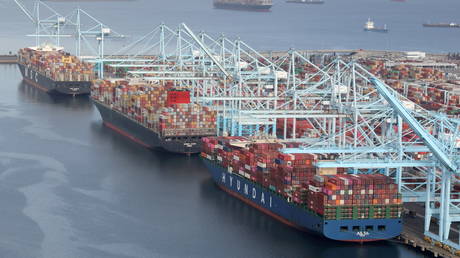 FILE PHOTO: Shipping containers are unloaded from ships at a container terminal at the Port of Long Beach-Port of Los Angeles complex, in Los Angeles, California, April 7, 2021.