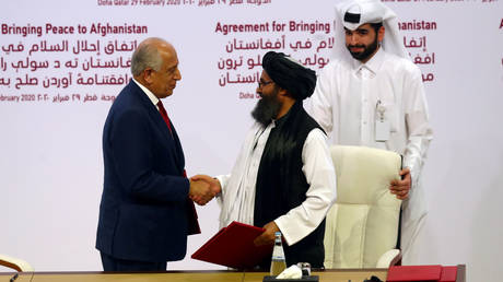 FILE PHOTO: Mullah Abdul Ghani Baradar, the leader of the Taliban delegation, and Zalmay Khalilzad, US envoy for Afghanistan, shake hands after signing an agreement in Doha, Qatar, February 29, 2020.