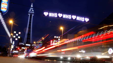 Cars pass under a tribute to Britain's NHS (National Health Service) as part of the Illuminations in Blackpool