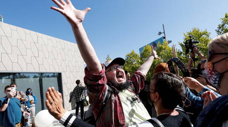 Counter-protester Vito Gesualdi gestures in front of demonstrators attending the a Netflix walkout protest in Los Angeles