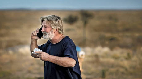 Alec Baldwin speaks on phone outside Santa Fe County Sheriff's Office after he was questioned about a shooting on set of the film "Rust", Oct. 21, 2021