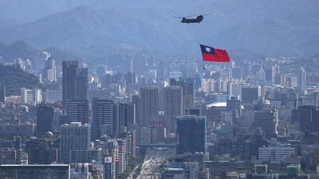 FILE PHOTO: A Taiwan flag is carried by a Chinook helicopter in Taipei, Taiwan on October 7, 2021.