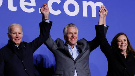 Democratic candidate for governor of Virginia Terry McAuliffe reacts between his wife Dorothy and US President Joe Biden at a rally in Arlington, Virginia, US October 26, 2021. © REUTERS / Jonathan Ernst