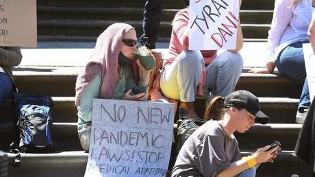 FILE PHOTO: Protesters sit on the steps of the Victorian parliament in Melbourne on October 26, 2021