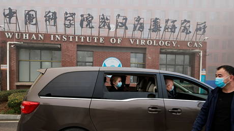 FILE PHOTO. World Health Organization (WHO) investigators arrive at Wuhan Institute of Virology. ©REUTERS / Thomas Peter