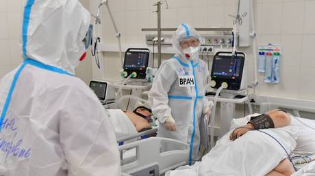 Medical workers treat patients in the intensive care unit of a temporary Covid-19 hospital in Moscow, Russia.