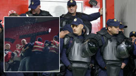 ‘It was partly my fault’: Poland forced to flee as fans hurl missiles after star celebrates goal in crunch World Cup game (VIDEO)