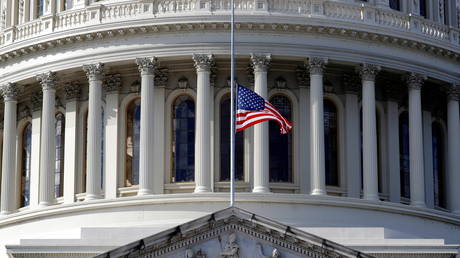 FILE PHOTO: An American flag at the US Capitol is flown at half-mast in January, two weeks after rioters breached the building.