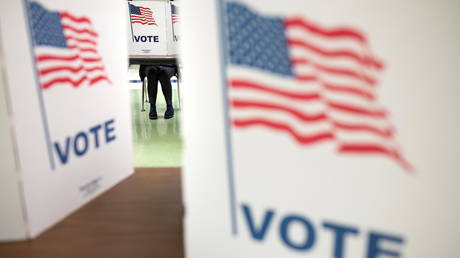 A voter fills a ballot during the Virginia Governor Race, at Spring Hill Elementary School in McLean, Virginia, November 2, 2021.