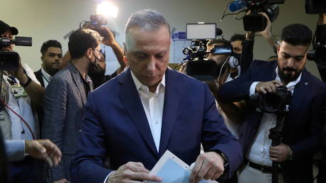 FILE PHOTO: Iraqi Prime Minister Mustafa Al-Kadhimi casts his vote at the polling station at the Green Zone in Baghdad, as Iraqis go to the polls to vote in the parliamentary election, in Iraq, October 10, 2021. © REUTERS/Ahmed Saad