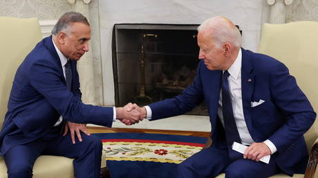US President Joe Biden greets Iraq's Prime Minister Mustafa Al-Kadhimi during a meeting in the Oval Office at the White House, July 26, 2021