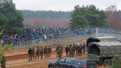 Polish soldiers guard hundreds of migrants at the Polish/Belarus border near Kuznica Bialostocka, Poland.