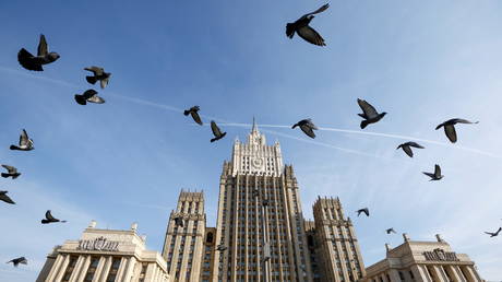 FILE PHOTO. Pigeons fly in front of the headquarters of the Russian Foreign Ministry in Moscow, Russia.