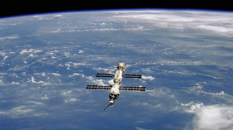The International Space Station (ISS) over a moderately cloud-covered land area. © Reuters