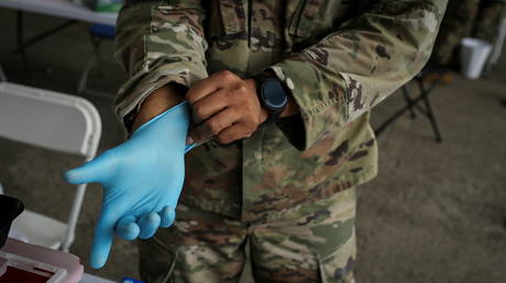 FILE PHOTO: A US Army soldier prepares to administer Covid-19 vaccines at an immunization site in Miami, Florida.