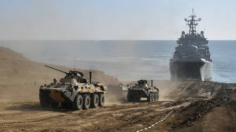 A BTR-82A armored personnel carrier lands from a large landing ship during an exercise in the amphibious landing on an unimproved shore held by army corps and naval infantry units of the Russian Black Sea Fleet at the Opuk range, in Crimea, Russia. © Sputnik / Konstantin Mihalchevskiy