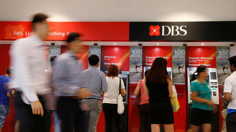 People queue up to withdraw money from DBS ATMs at a mall in Singapore, May 3, 2016.