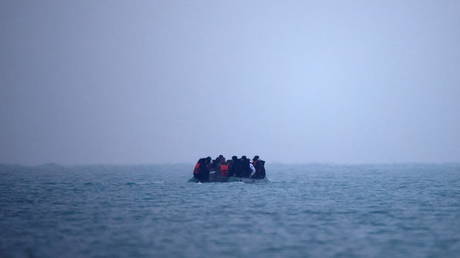 A group of more than 40 migrants on an inflatable dinghy leave the coast of northern France to cross the English Channel on November 24, 2021.