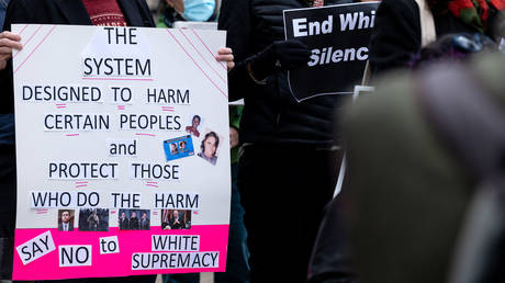 A protester with a sign is seen outside of the Hall of Justice during the Reject the Verdict rally on November 20, 2021 in Louisville, Kentucky.