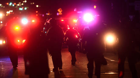 FILE PHOTOS: Police officers chase a group of protesters during a demonstration in Oakland, California, November 9, 2016.