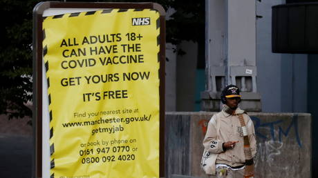 FILE PHOTO: A billboard encouraging people to get vaccinated against Covid-19 in Manchester, UK, October 2021. © Reuters/Phil Noble