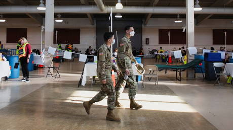 FILE PHOTO: National Guard troops walk through a Covid-19 vaccination site.