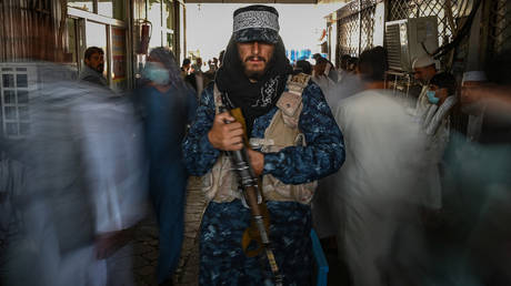A Taliban fighter stands guard at a market in Kabul, Afghanistan, September 5, 2021.