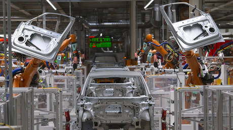 Robots work on an electric car ID.3 body at the assembly line at the plant of the German manufacturer Volkswagen AG (VW) in Zwickau, Germany