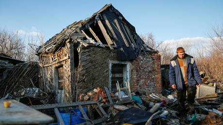 FILE PHOTO. Local resident Victor Luksha, 31, walks past his family's property damaged by shelling, in Donetsk, Ukraine. © Reuters / Alexander Ermochenko