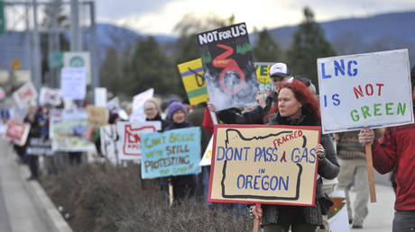 People protest against the Jordan Cove LNG Pipeline on Crater Lake Highway in Medford, Ore., on Jan. 6, 2016