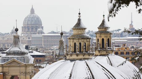 View of rooftops of Rome with snow from Borghese gardens, Italy