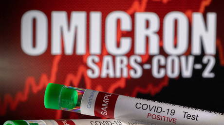 Test tubes labelled "COVID-19 Test Positive" are seen in front of displayed words "OMICRON SARS-COV-2." © Reuters / Dado Ruvic