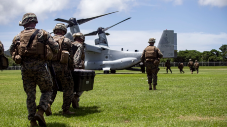 US Marines and sailors with the 31st Marine Expeditionary Unit, carry gear into an MV-22 while conducting on and off drills  at Camp Hansen, Okinawa, Japan, on May 17, 2021
