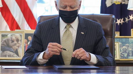 President Joe Biden signs the Paycheck Protection Program (PPP) Extension Act of 2021 into law in the Oval Office at the White House, March 30, 2021